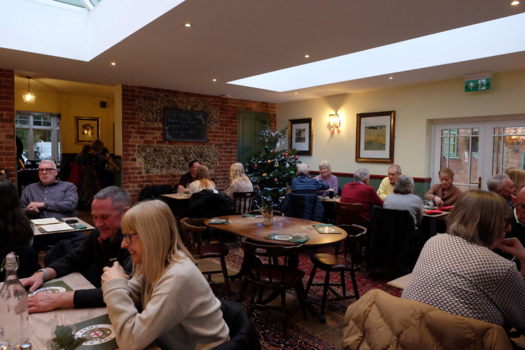 Very busy dining area in local country pub with Christmas tree in the corner