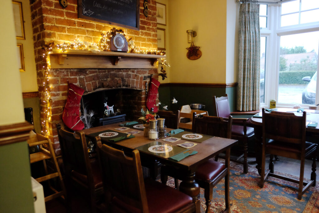 Dining area in a pub with fireplace to the left